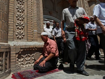 In this Friday, July 10, 2009 file photo, Muslim worshipers come out of a mosque after noon prayers in Kashgar, China. Two knife-wielding men hijacked a truck in China's restive northwest, then rammed the vehicle into a crowd and got out to attack the pedestrians, sparking clashes, a police official said Sunday. The attack happened in the Silk Road city of Kashgar in northwest Xinjiang, a region rocked by ethnic violence in recent years. (AP-Yonhap News)