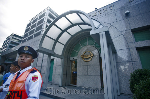 A security guard stands outside the Asian Development Bank headquarters in Manila.  Bloomberg