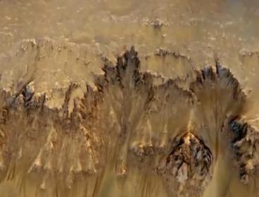 This captured picture shows water flows that appear in spring and summer on a slope inside Mars' Newton crater. (NASA via YouTube)