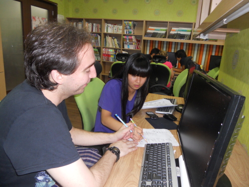 KKOOM logo\r\nKKOOM volunteer Danny DiCrispino works with Sora, an Emmanuel middle school student.     KKOOM