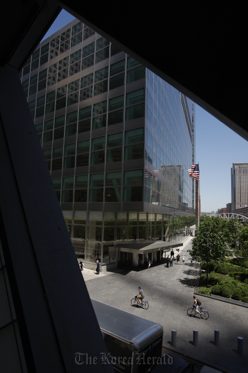 Cyclists pass the headquarters of Goldman Sachs Group Inc. in New York.  Bloomberg