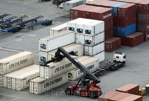 A straddle carrier transports a shipping container at the Port of Pyeongtaek.   Bloomberg