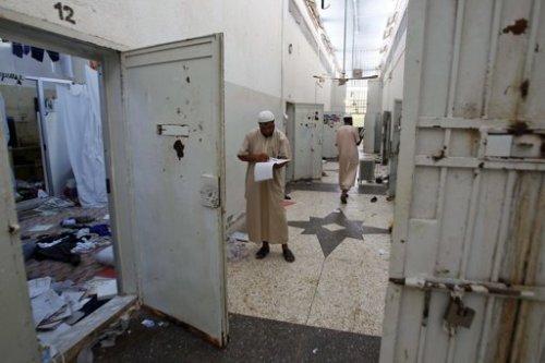In this Saturday, Aug. 27, 2011 file photo, Libyans search for documents inside Abu Salim prison, Libya's most notorious prison of Gadhafi's regime and the scene of a 1996 massacre of prisoners, in Tripoli, Libya. (AP)