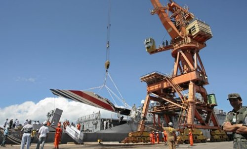 In this June 14, 2009 file photo, workers unload debris, belonging to crashed Air France flight 447, from the Brazilian Navy's Constitution Frigate in the port of Recife, northeast of Brazil. Airline industry and safety officials are concerned that pilots’ flying skills are becoming rusty and their ability to handle unexpected situations is eroding because most flying is delegated to computers in today’s highly automated planes. Last month, French investigators recommended that all pilots get mandatory training in manual flying and handling a high-altitude stall. The recommendations were in response to the 2009 crash of the Air France jet flying from Brazil to Paris. All 228 people aboard were killed. (AP)