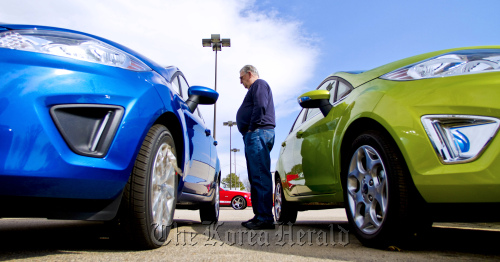 A customer looks at a 2011 Ford Motor Co. Fiesta at the Capital Ford dealership in Raleigh, North Carolina.  Bloomberg