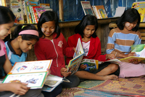 Burmese refugees read at a Book for Dream library at a refugee camp on the Thai-Burmese border. (B4D)