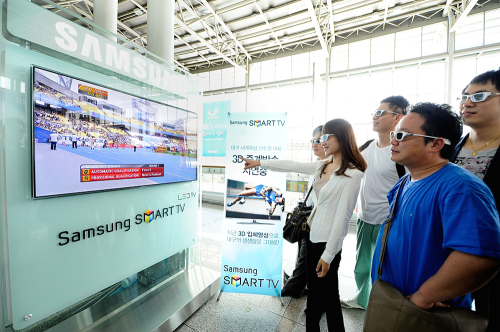 A model showcases a 27 inch “Cinema 3-D TV” in Seoul on\r\nThursday. (LGE)