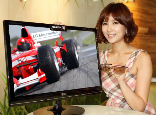 A model showcases a 27 inch “Cinema 3-D TV” in Seoul on\r\nThursday. (LGE)