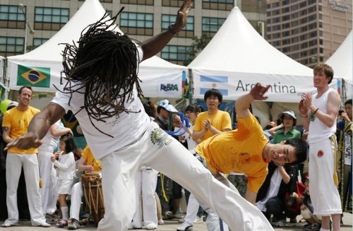 Munair Simpson vies against a rival capoeirista at an event in Seoul.     CDO Seoul