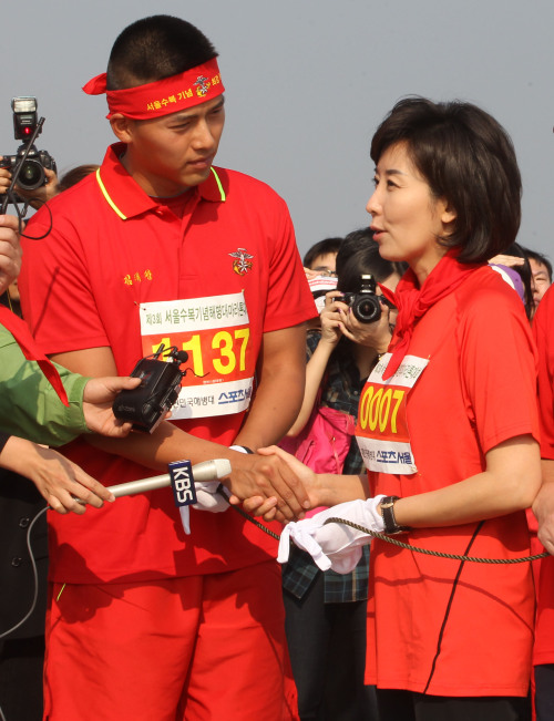 <YONHAP PHOTO-0910> 나경원, 현빈과 악수 (서울=연합뉴스) 임헌정 기자 = 한나라당 나경원 최고위원이 25일 서울 여의도한강공원에서 열린 제3회 서울수복 기념 해병대 마라톤대회에서 해병대에 복무 중인 배우 현빈과 예포 발사에 앞서 악수하고 있다. 2011.9.25 kane@yna.co.kr/2011-09-25 10:14:07/ <저작권자 ⓒ 1980-2011 ㈜연합뉴스. 무단 전재 재배포 금지.>\r\nRep. Na Kyung-won of the Grand National Party (right) shakes hands with Hyun Bin, a former actor currently serving his military service in the Marines, during a marathon event in Yeouido, Seoul on Sunday.  Yonhap News