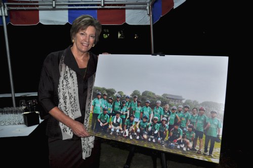 U.S. Ambassador Kathleen Stephens poses next to a poster showing the embassy’s bicycle squad that\r\ntraveled to many parts of the country. (Yoav Cerralbo/The Korea Herald)