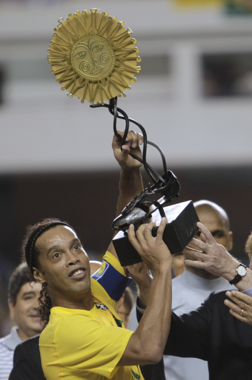 <YONHAP PHOTO-1171> Brazil's Ronaldinho holds up a trophy as he celebrates with teammates after defeating Argentina in a soccer friendly match in Belem, Brazil, Wednesday, Sept. 28, 2011. Brazil won 2-0. (AP Photo/Andre Penner)/2011-09-29 13:38:18/ <저작권자 ⓒ 1980-2011 ㈜연합뉴스. 무단 전재 재배포 금지.>\r\nBrazil’s Ronaldinho holds up the winner’s trophy after his side beat Argentina 2-0 in a soccer friendly on Wednesday. \n AP-Yonhap News