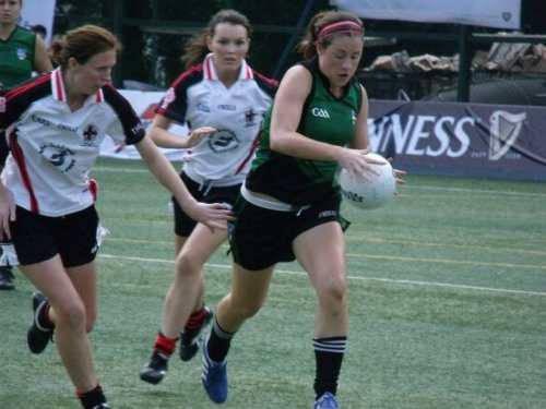 A Seoul Gaels player tries to fend off her opponents from the Dubai Celts.  Seoul Gaels