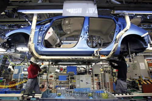 Nissan Motor Co. employees assemble a Leaf electric vehicle on the production line of the company’s Oppama plant in Yokosuka City, Japan.  Bloomberg