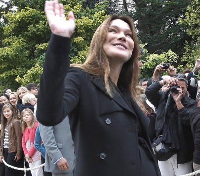 France's first lady Carla Bruni-Sarkozy waves in the gardens of the Elysee Palace in Paris. (AP)