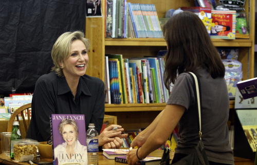 Actress and now book author Jane Lynch, left, one of the stars of the TV show “Glee,” signs copies of her new memoir, “Happy Accidents,” at Women and Children First bookstore in Andersonville neighborhood of Chicago, Illinois, on Oct. 9.  (Chuck Berman/Chicago Tribune/MCT)