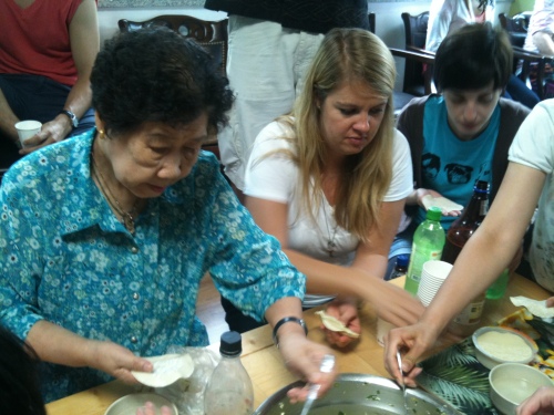 Guests help make mandu with halmoni at the House of Sharing on a previous visit.    House of Sharing