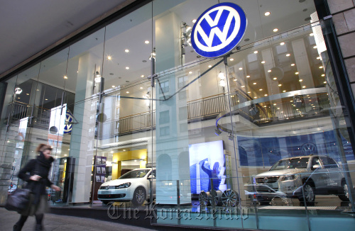 A pedestrian passes a Volkswagen dealership in Berlin, Germany.  Bloomberg