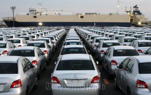 Toyota Motor Corp. Yaris compact vehicles bound for export sit in a lot at the port of Sendai, Japan.  Bloomberg