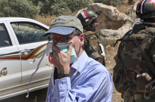 <YONHAP PHOTO-2132> FILE - In this June 20, 2011 photo taken during a government-organized tour for foreign diplomats and the media, US ambassador in Syria Robert Ford, covers his nose during his visit with other foreign diplomats to a mass grave, in Jisr el-Shughour, north of Syria. State Department spokesman Mark Toner said Monday, Oct. 24, 2011, that Ambassador Robert Ford returned to Washington this weekend after "credible threats against his personal safety." (AP Photo/Bassem Tellawi, File)/2011-10-24 21:01:24/ <저작권자 ⓒ 1980-2011 ㈜연합뉴스. 무단 전재 재배포 금지.>
U.S. ambassador to Syria Robert Ford covers his nose during his visit to a mass grave in northern Syria on June 20. AP-Yonhap News