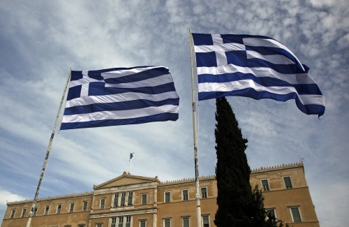 Greek national flags fly outside the parliament building in Athens, Greece, on Thursday, Oct. 27, 2011. The new package will reduce debt by about 100 billion euros and the interest the country pays by as much as 5 billion euros a year, providing a firmer basis for Greece to put reforms in place and begin producing primary surpluses, Greece's Finance Minister Evangelos Venizelos told reporters in Athens yesterday. Photographer: Angelos Tzortzinis/Bloomberg
Greek national flags fly outside the parliament building in Athens.
Bloomberg