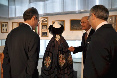 Italian Ambassador Sergio Mercuri (left) and Italian Cultural Institute director Lucio Izzo (right) listen to Francesco Reggiani, the curator and director of the Historical Archive of Teatro dell’Opera di Roma, and discuss the dress for the character of Violetta, the protagonist in “La Traviata,” which was created in 1928 by famed designer Luigi Sapelli (Caramba). (Italian Embassy)