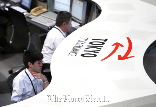 Traders work at the Tokyo Stock Exchange.  Bloomberg