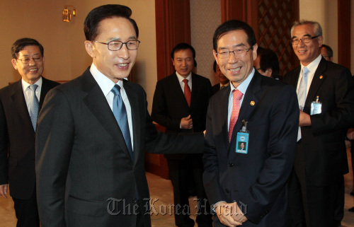 President Lee Myung-bak greets liberal Seoul Mayor Park Won-soon at a Cabinet meeting composed of conservatives at Cheong Wa Dae on Tuesday.    Yonhap News