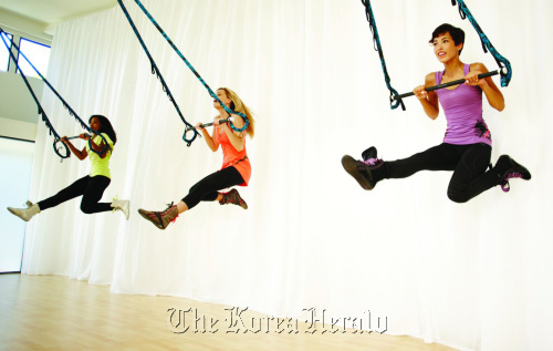 Women enjoy working out at a gym. More people are using their lunch break for exercise due to their tight work schedule. MCT