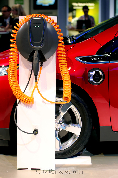 The plug for the General Motors Co. Chevrolet Volt electric vehicle sits on display at New York International Auto Show.  Bloomberg