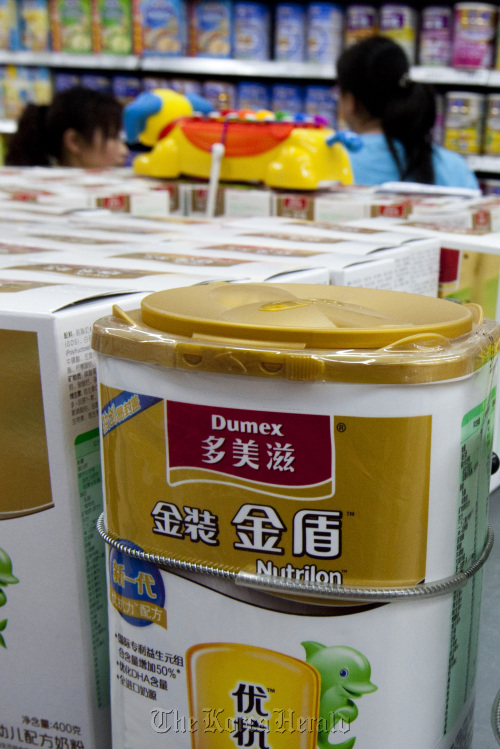 Customers shop for infant baby formula at a store in Beijing.  Bloomberg
