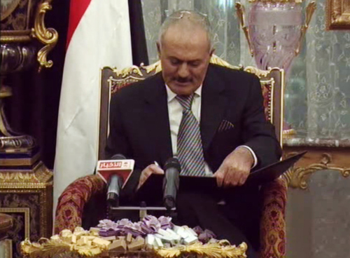 <YONHAP PHOTO-0473> In this image made from video broadcast by Yemen State TV and accessed via APTN, Yemeni President Ali Abdullah Saleh signs a document agreeing to step down after a long-running uprising to oust him from 33 years in power in Riyad, Saudi Arabia, Wednesday, Nov. 23, 2011. Saleh, seated beside Saudi King Abdullah in the Saudi capital Riyadh, signed a U.S.-backed deal hammered out by his country's powerful Gulf Arab neighbors to transfer his power within 30 days to his vice president, Abed Rabbo Mansour Hadi. (AP Photo/APTN)/2011-11-24 06:03:15/ <저작권자 ⓒ 1980-2011 ㈜연합뉴스. 무단 전재 재배포 금지.>
Yemeni President Ali Abdullah Saleh signs a document agreeing to step down in Riyadh, Saudi Arabia, Wednesday.  AP-Yonhap News