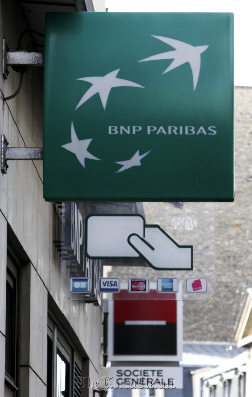 A BNP Paribas SA sign hangs near one for Societe Generale SA in Paris.  Bloomberg