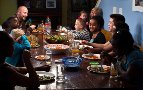 Kiel and Carolyn Twietmeyer sit down for dinner with their 13 children, including six adopted from Africa, on Nov. 2 (Chicago Tribune/MCT)