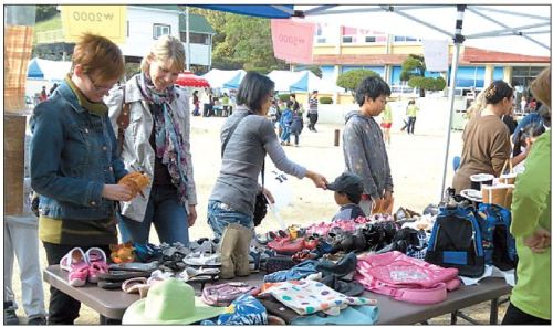 Shoppers browse goods being sold at Geoje English Village jumble sale. (GEV)
