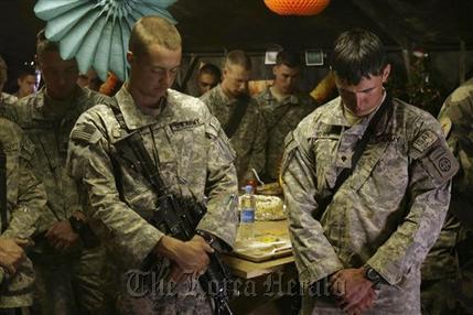 U.S. soldiers offer prayers during a Thanksgiving Day celebration at a forward operating base in Wardak, Afghanistan, on Nov. 22, 2007.    AP