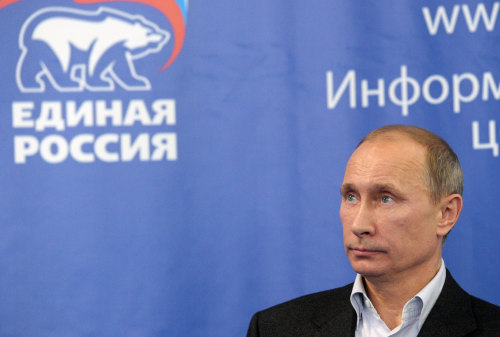 Prime Minister Vladimir Putin, with the emblem of the United Russia party in the background, visits the United Russia party headquarters in Moscow, Saturday, Dec. 4, 2011. (AP)