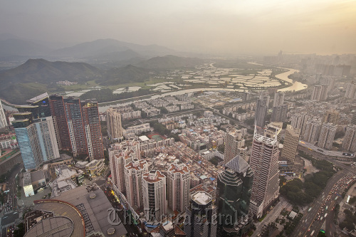 Residential and commercial properties are illuminated at dusk in the Louhu district of Shenzhen in Guangdong Province, China.  Bloomberg