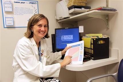 Dr. Eliana Perrin of the University of North Carolina, Chapel Hill,
holding a stoplight-colored growth chart that helps track when
children are overweight for their height. (AP)
