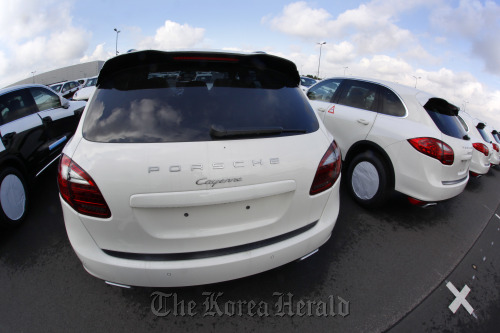 Porsche SA Cayenne automobiles sit waiting for delivery at the company’s factory in Leipzig, Germany.  Bloomberg