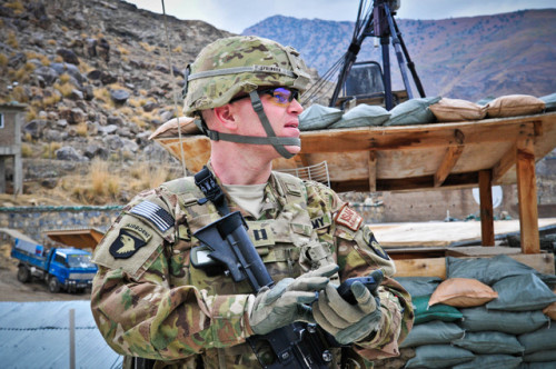 U.S. Army Capt. Jonathan Springer, an active duty artillery officer, uses his iPhone application Tactical Nav at Camp Blessing, Afghanistan in this February 2011 photo provided to the media. (Bloomberg)