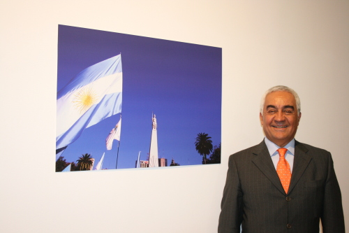 Argentine Ambassador to Korea Carlos Alberto Arganaraz
stands next to a photo at the Buenos Aires exhibition in
Seoul on Tuesday. (Kirsty Taylor/The Korea Herald)