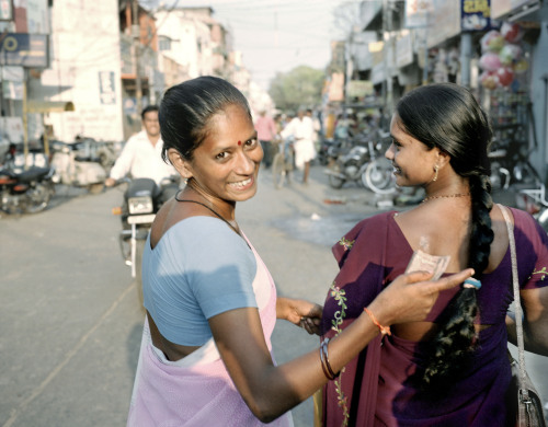 SHARING PAGE
Satyaveni Kamadi walks with a friend after benefiting from treatment provided by the Global Fund.  Jim Goldberg