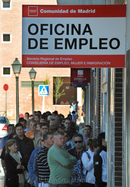 Jobseekers line up at an employment office in Madrid,
Bloomberg