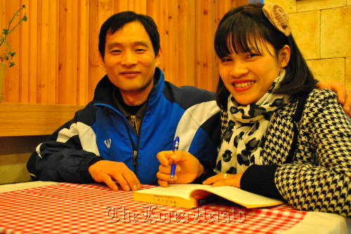Lee Nam-gil poses with his wife Ho Chi Wan, who is on her way to complete all of her education in Korea.   Robert Lee/The Korea Herald