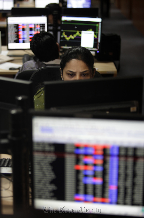 Stock brokers trade at Motival Oswal Securities Ltd. in Mumbai.  Bloomberg