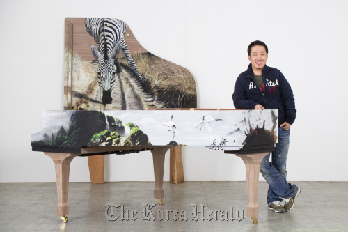 Artist Kim Nam-pyo poses with his work “Instant Landscape” at the exhibition “Art Forte.” Gana Art Center