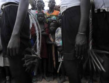 In a picture taken on November 11, 2011, people watch as traditional dancers perform during a show in Nyal, south Sudan. (AFP)