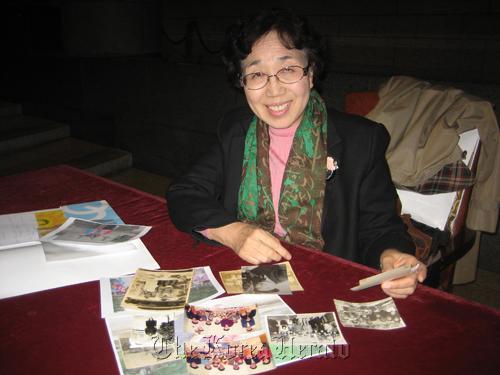 Kim Young-ja looks through pictures of her family in North Korea.   Courtesy of Jason Strother
Kim Young-ja looks through pictures of her family in North Korea.   Courtesy of Jason Strother