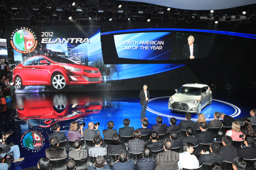 Hyundai Motor America CEO John Krafcik (standing) is seen after the Hyundai Elantra was awarded the 2012 North American Car of the Year award at the 2012 North American International Auto Show in Detroit on Monday.  Hyundai Motor